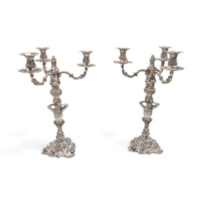 Pair of silver three-light candelabra with figural stems and rococo scroll bases