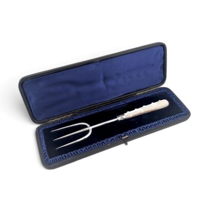 Victorian silver bread fork with carved white handle in its fitted blue-lined case