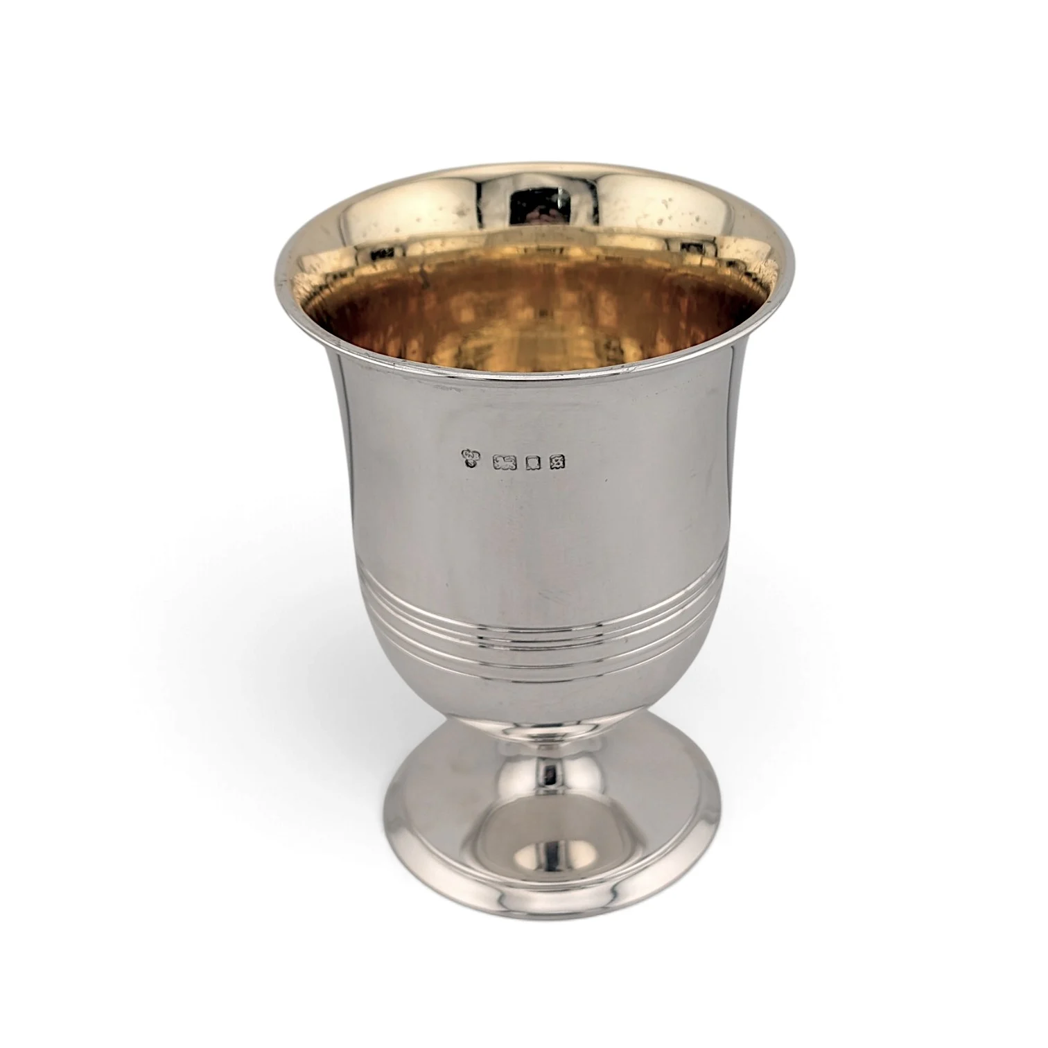Silver cup on a pedestal foot with reeded bands and gilt interior, London 1933