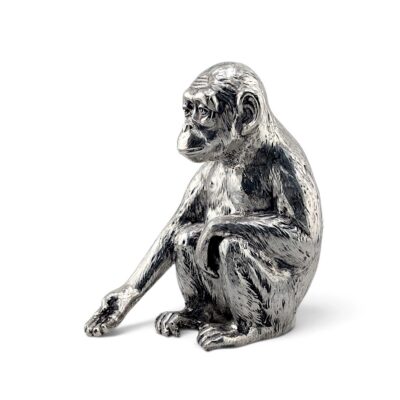 Seated silver monkey figure, three-quarter view