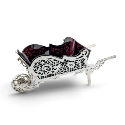 Silver wheelbarrow with pierced scrolling sides and a cranberry glass liner