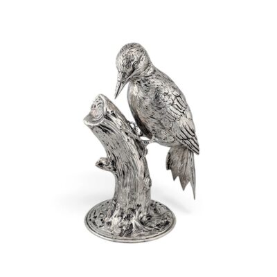 Silver woodpecker figure perched on a tree-stump base