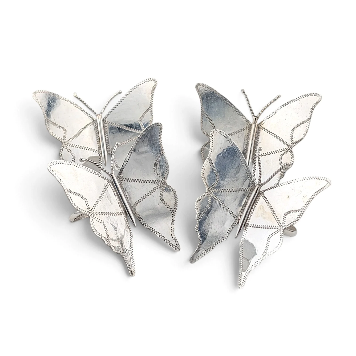 Two silver butterfly napkin rings with beaded wing edges