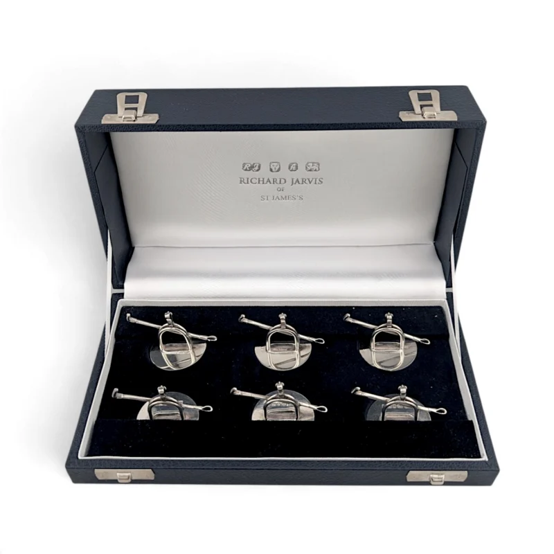 Six silver stirrup menu holders in a Richard Jarvis presentation case