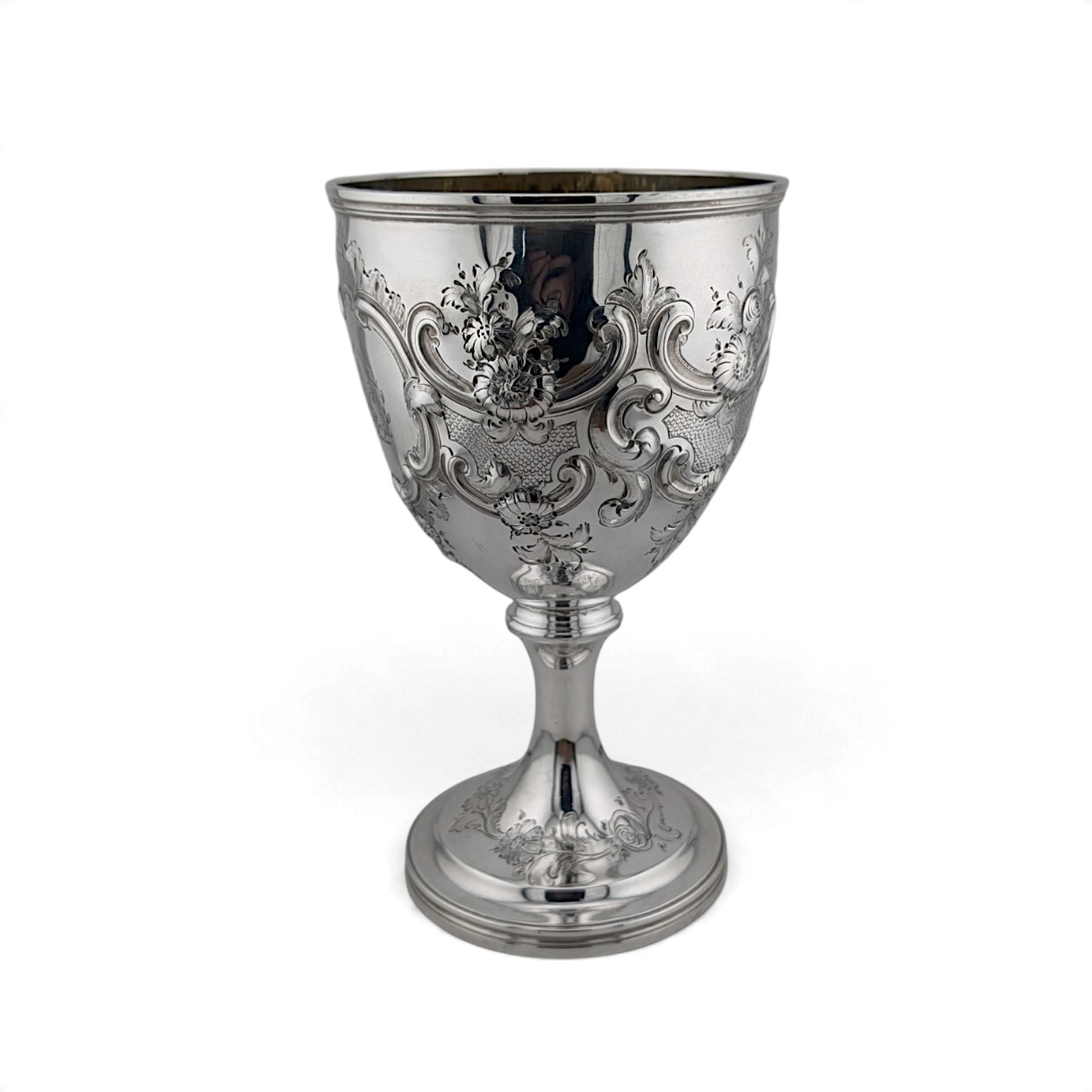 Georgian silver goblet chased with flowers and foliage around a central cartouche