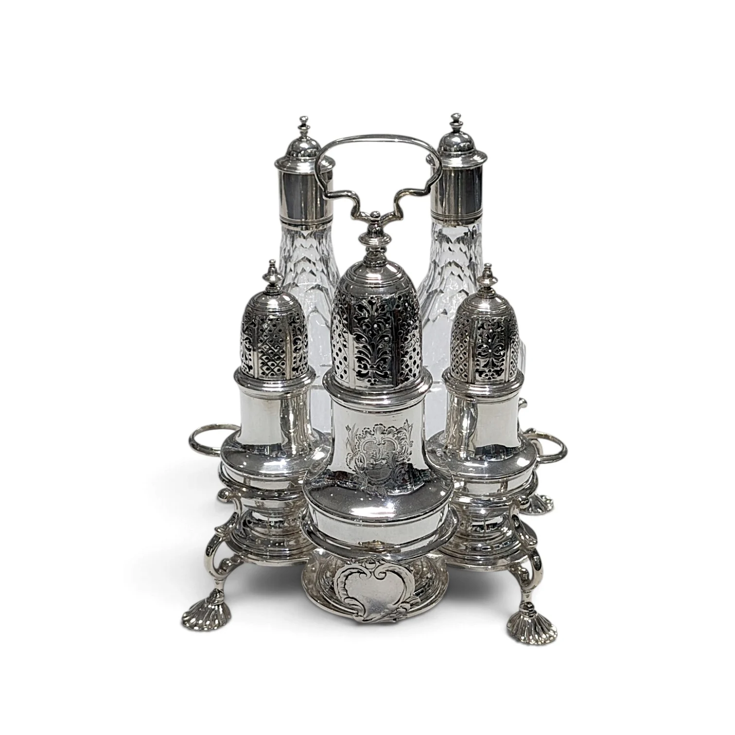 Silver cruet frame holding three pierced casters and two cut-glass bottles