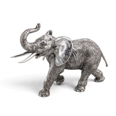 Silver elephant walking with its trunk raised and tusks forward