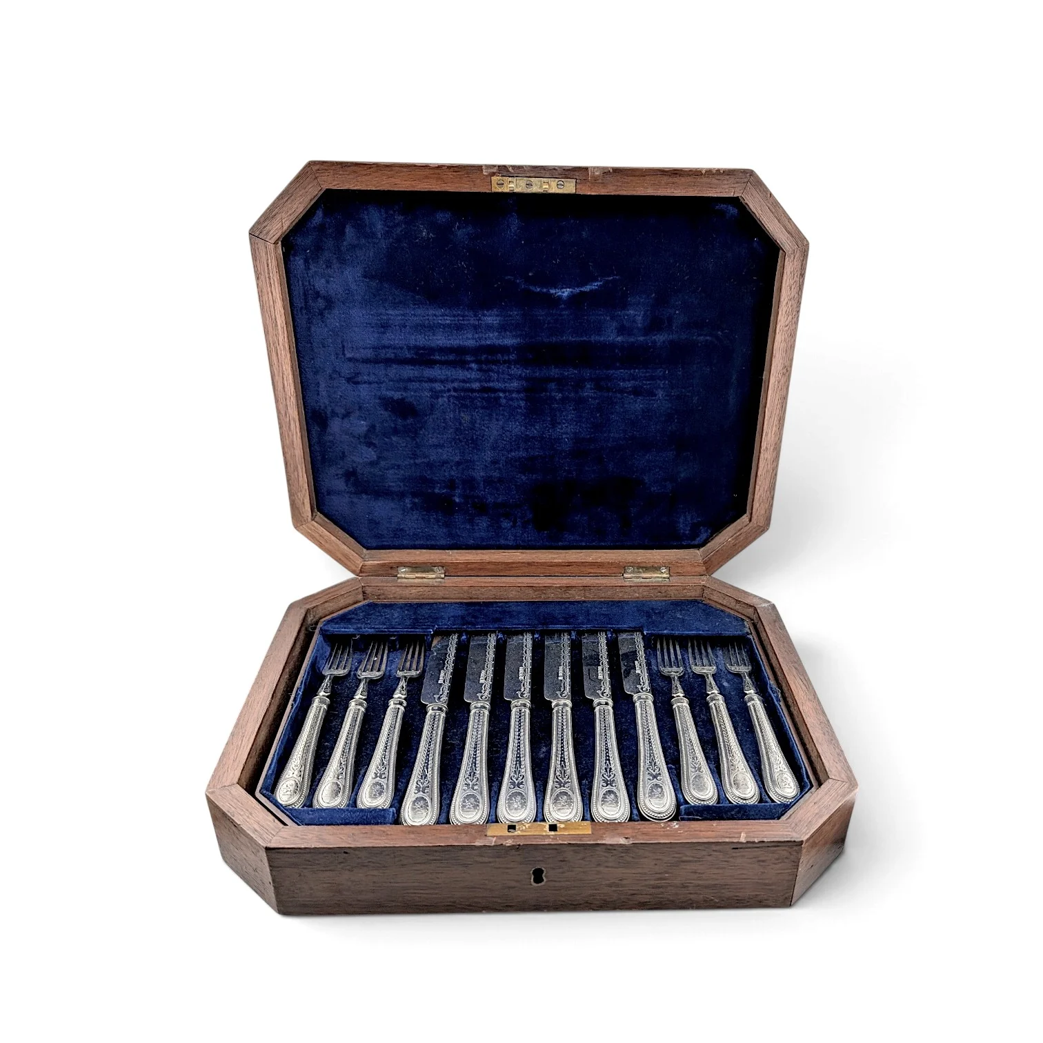 Engraved fish knives and forks laid out in their fitted oak and blue velvet case