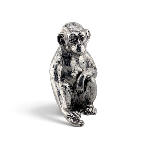Seated silver monkey figure, front view