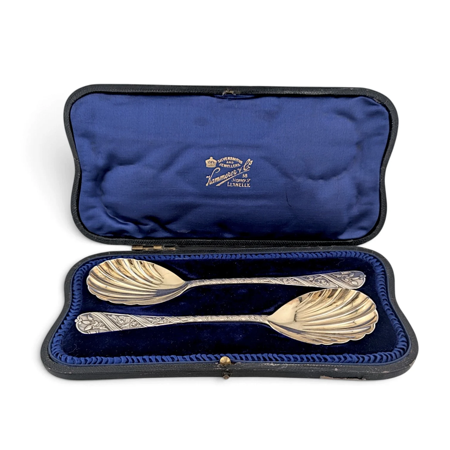 Pair of silver serving spoons with gilded shell bowls in a blue silk-lined case