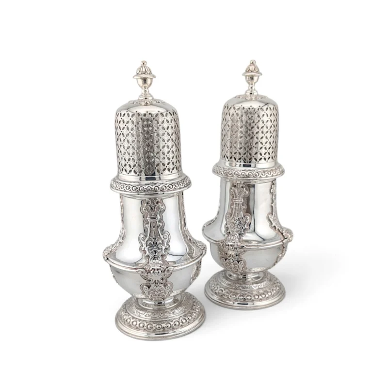 Pair of tall silver casters with pierced covers