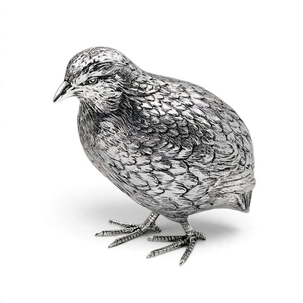 Standing silver quail seen from the side