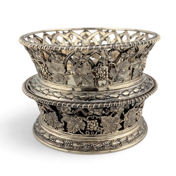 Two silver-gilt wine coasters stacked