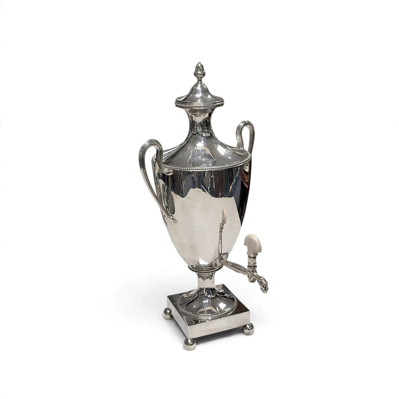 Georgian silver tea urn with twin handles, front tap and square base on ball feet