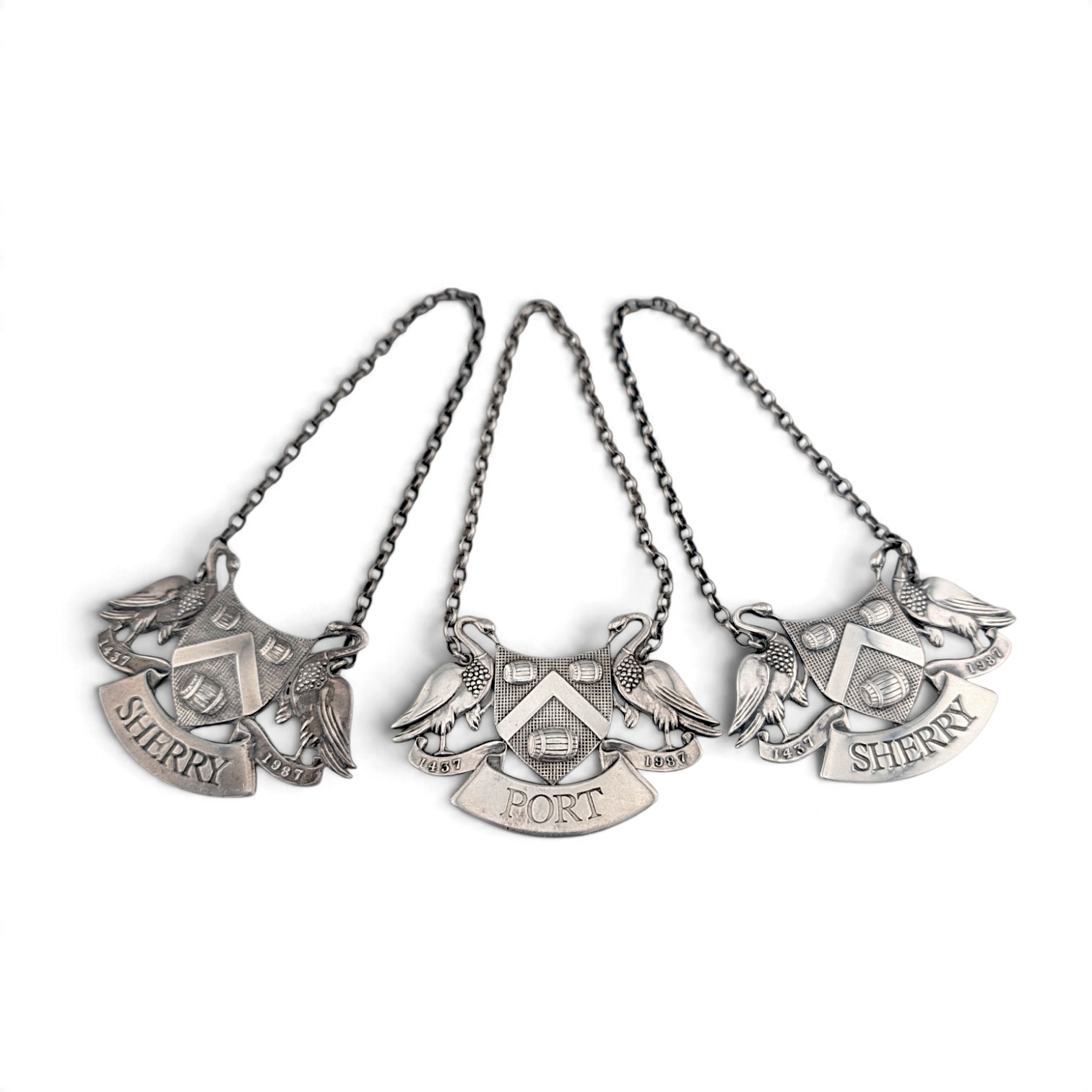 Three silver wine labels for Sherry, Port and Sherry, each with swan-supported arms
