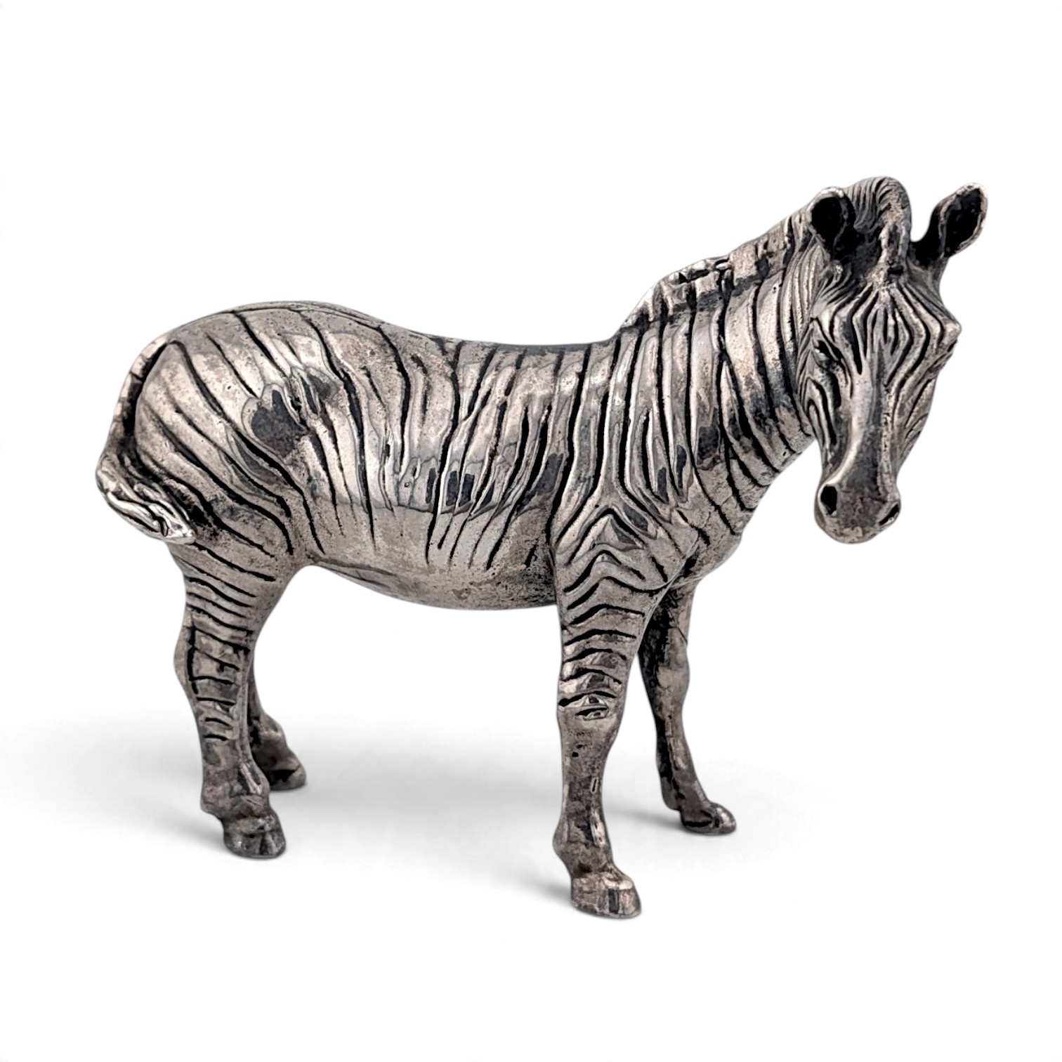 Silver zebra figure standing, with finely chased stripes